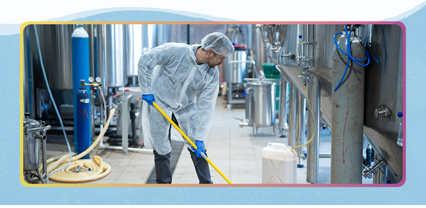 man cleaning in a warehouse-like setting